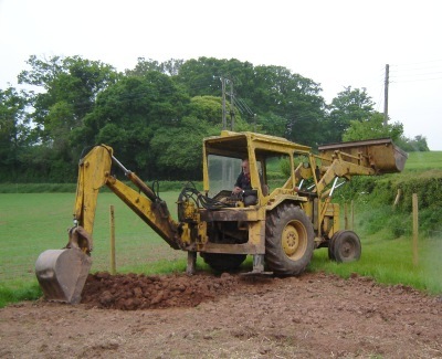Derricking using a backhoe digger